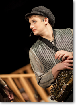 actor holding saxophone